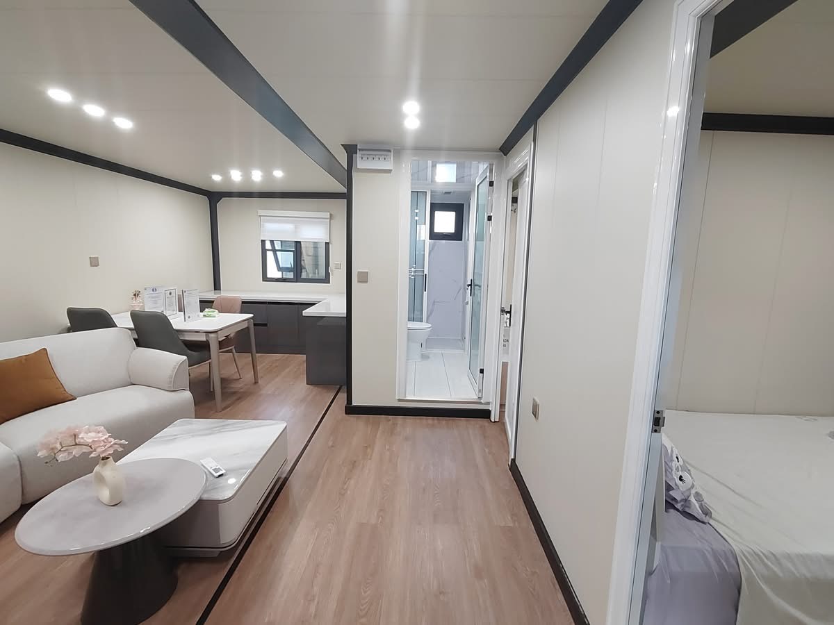 Interior view of bahria homes Castle Expandable House E20 showing living room, dining area, bathroom, and bedroom in a modern modular home design