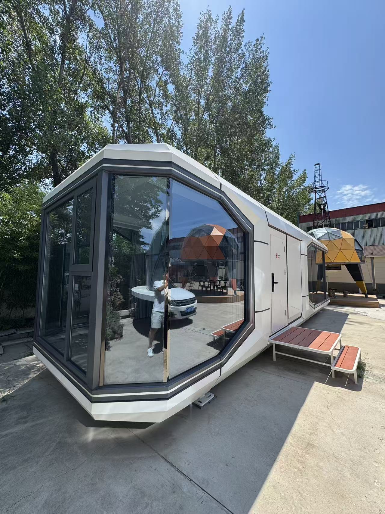 Side perspective of the bahria homes House D7 modular smart pod featuring large panoramic glass windows, sleek white exterior, and futuristic architectural styling.