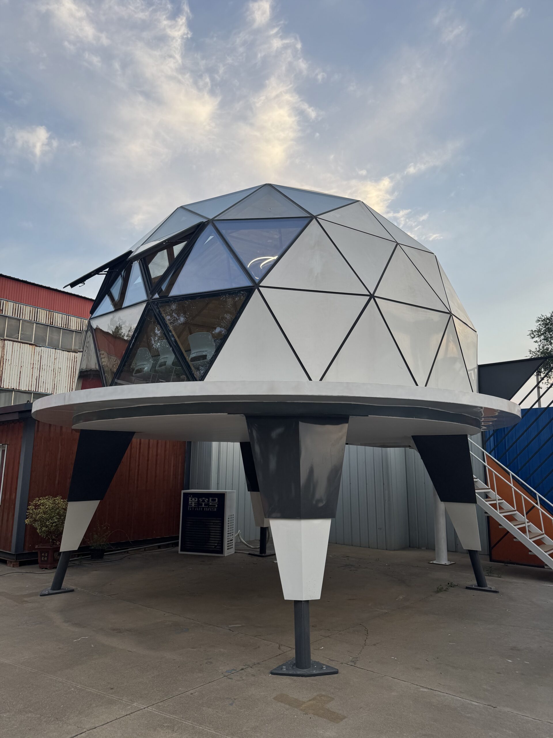 Angled view of the bahria homes House C7 Plus elevated dome pod with geometric glass panels and futuristic design, representing modern modular living by bahria homes Castle.