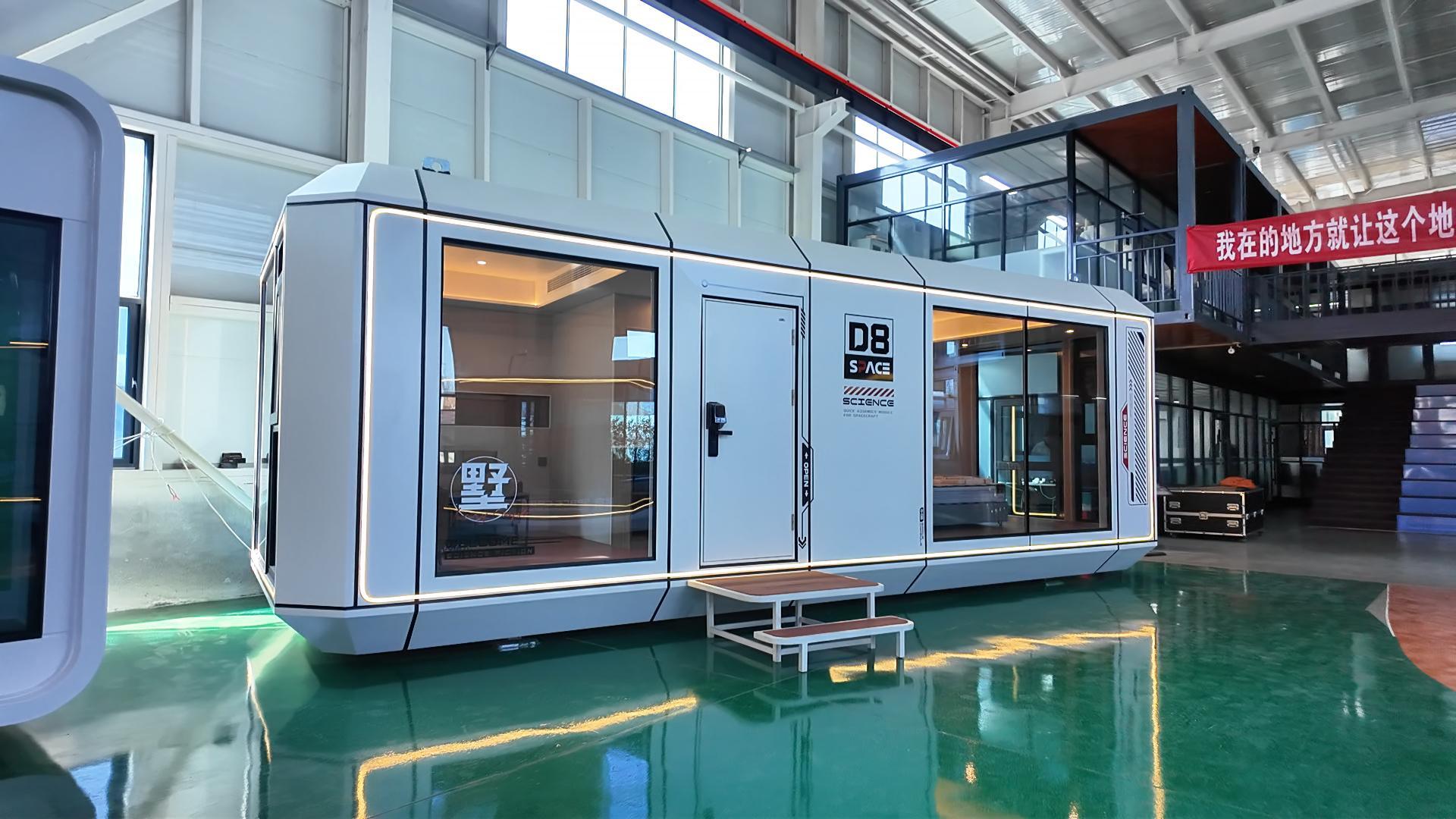 Real-life exterior view of the bahria homes House D8 smart modular unit showcasing its sleek white design, large glass panels, and modern architectural lighting.